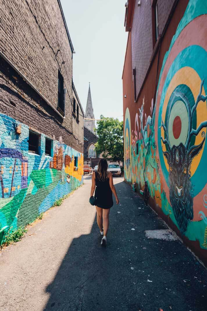 Megan walking through a street art alley in Halifax Nova Scotia